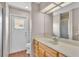 Bathroom with wood-look flooring, a wood vanity, decorative tile and an exterior access door at 113 W Juliana Way, Auburndale, FL 33823