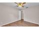 Bedroom featuring wood laminate flooring, ceiling fan and access to adjacent room at 113 W Juliana Way, Auburndale, FL 33823