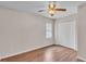 Bright bedroom features wood-look floors, neutral walls, and ceiling fan at 113 W Juliana Way, Auburndale, FL 33823