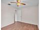 Light and airy bedroom with wood-look floors and a ceiling fan at 113 W Juliana Way, Auburndale, FL 33823