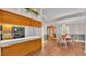 Open-concept view of the dining room with stylish light fixture, flowing to the kitchen and living areas at 113 W Juliana Way, Auburndale, FL 33823