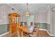 Elegant dining room featuring a wooden table, china cabinet, and a stylish chandelier that illuminates the space at 113 W Juliana Way, Auburndale, FL 33823