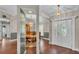 Inviting entryway with rich wood floors, decorative light fixture, and charming double doors showcasing the home's character at 113 W Juliana Way, Auburndale, FL 33823