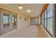 Spacious Florida room with tiled floor, lots of windows and multiple doors at 113 W Juliana Way, Auburndale, FL 33823