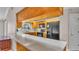 Charming kitchen featuring wood cabinetry, black appliances, and a pass-through bar for entertaining guests at 113 W Juliana Way, Auburndale, FL 33823