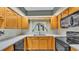 Well-lit kitchen with bright cabinets, neutral countertops and modern appliances at 113 W Juliana Way, Auburndale, FL 33823