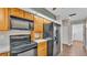 Kitchen featuring stainless steel appliances and warm-toned wood cabinets at 113 W Juliana Way, Auburndale, FL 33823