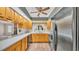 Cozy kitchen featuring light-colored cabinets, black appliances, and a sink with a view of the outdoors at 113 W Juliana Way, Auburndale, FL 33823