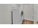 Laundry room with stacked washer and dryer and wire shelving for storage at 113 W Juliana Way, Auburndale, FL 33823