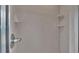 Tiled shower stall featuring built in soap and shampoo shelves and a chrome shower head fixture at 113 W Juliana Way, Auburndale, FL 33823