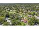 Neighborhood aerial view of lush community with mature trees and single-Gathering homes, some with private pools at 1210 Heidi S Ln, Lakeland, FL 33813