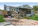This backyard has a spacious deck with stairs and a brick patio at 1210 Heidi S Ln, Lakeland, FL 33813