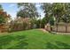 Large backyard with a well-maintained lawn, wooden fence, and above-ground pool at 1210 Heidi S Ln, Lakeland, FL 33813