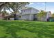 Large, lush backyard with mature trees and landscaping, screened-in porch visible at 1210 Heidi S Ln, Lakeland, FL 33813