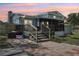 View of the home's backyard with brick patio, screened in porch, deck, and privacy fence at 1210 Heidi S Ln, Lakeland, FL 33813