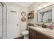 Bathroom featuring dark wood vanity, modern fixtures, and a new shower with white tile at 1210 Heidi S Ln, Lakeland, FL 33813