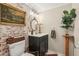 Charming bathroom with exposed brick accent wall, classic fixtures and decor at 1210 Heidi S Ln, Lakeland, FL 33813