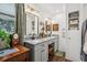 Updated bathroom featuring dual sinks, granite countertops, shiplap, and plenty of storage at 1210 Heidi S Ln, Lakeland, FL 33813
