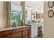 Updated bathroom with dual sinks, granite counters, shiplap walls and decorative mirrors at 1210 Heidi S Ln, Lakeland, FL 33813