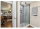 Bathroom with a modern gray-tiled shower, glass door, and stylish fixtures at 1210 Heidi S Ln, Lakeland, FL 33813