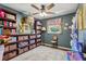 Cozy bedroom with hardwood floors, built-in shelving, ceiling fan, and bright natural light at 1210 Heidi S Ln, Lakeland, FL 33813