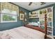 This bedroom features a four-poster bed, open shelves for storage, and a window view at 1210 Heidi S Ln, Lakeland, FL 33813