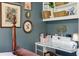 Bedroom featuring a white built-in desk with bookshelves and eclectic wall decor at 1210 Heidi S Ln, Lakeland, FL 33813
