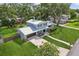 Charming two-story home featuring a metal roof, manicured lawn, and a driveway leading to the attached two car garage at 1210 Heidi S Ln, Lakeland, FL 33813