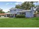 Charming two-story home with a well-manicured lawn and mature trees at 1210 Heidi S Ln, Lakeland, FL 33813