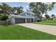 Two-story home with a well-manicured lawn, attached garage, and inviting front entrance at 1210 Heidi S Ln, Lakeland, FL 33813