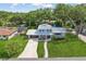 Charming two-story home featuring a metal roof, a well-manicured lawn, and a lovely walkway leading to the front door at 1210 Heidi S Ln, Lakeland, FL 33813