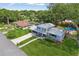Charming two-story home with well manicured lawn, metal roof, landscaping, and a private backyard pool and playground at 1210 Heidi S Ln, Lakeland, FL 33813