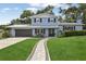 Charming two-story home with beautiful landscaping and a walkway to the front door at 1210 Heidi S Ln, Lakeland, FL 33813