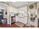 Bright kitchen features white cabinets, stainless appliances, a farmhouse sink and hardwood floors at 1210 Heidi S Ln, Lakeland, FL 33813
