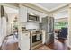 This is a bright kitchen featuring stainless steel appliances, white subway tile, and granite countertops at 1210 Heidi S Ln, Lakeland, FL 33813
