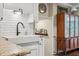 The kitchen sink area features subway tile backsplash, granite countertops, and dark hardware at 1210 Heidi S Ln, Lakeland, FL 33813