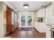 Eat-in-kitchen with white cabinets, stainless steel appliances, and a glass paneled china cabinet at 1210 Heidi S Ln, Lakeland, FL 33813