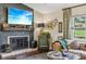 Well-lit living room with fireplace, TV, and large window at 1210 Heidi S Ln, Lakeland, FL 33813