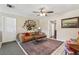 Cozy living room with tile floors, a ceiling fan, and a decorative rug and artwork at 1210 Heidi S Ln, Lakeland, FL 33813
