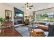 Cozy living room featuring a fireplace, large window, and hardwood floors at 1210 Heidi S Ln, Lakeland, FL 33813