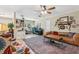 Open living space featuring tile floors, a ceiling fan, and a cozy seating area with a leather sofa at 1210 Heidi S Ln, Lakeland, FL 33813