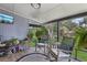 Screened patio with comfortable seating and a view of a large shady backyard with plants at 1210 Heidi S Ln, Lakeland, FL 33813
