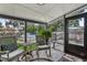 Relaxing screened-in patio with rocking chairs overlooking the deck and above-ground pool at 1210 Heidi S Ln, Lakeland, FL 33813