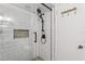 The renovated shower features subway tile, a rainfall shower head, and glass doors at 1210 Heidi S Ln, Lakeland, FL 33813