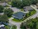 Impeccably landscaped single-Gathering home with verdant lawn and a dark roof at 128 Melissa Trl, Auburndale, FL 33823
