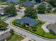 Lush green lawns and manicured shrubbery surround this single Gathering home with a dark roof at 128 Melissa Trl, Auburndale, FL 33823