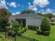 Well maintained backyard with lush green grass, manicured hedges, and a black aluminum fence at 128 Melissa Trl, Auburndale, FL 33823
