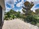 Lush backyard featuring beautiful landscaping, brick patio, and a wrought iron fence at 128 Melissa Trl, Auburndale, FL 33823