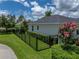 Fenced backyard featuring manicured hedges, lawn and landscaping elements providing a private outdoor space at 128 Melissa Trl, Auburndale, FL 33823