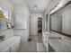 Hallway featuring a vanity with wood-look tile flooring, leading to a soaking tub and walk-in closet at 128 Melissa Trl, Auburndale, FL 33823